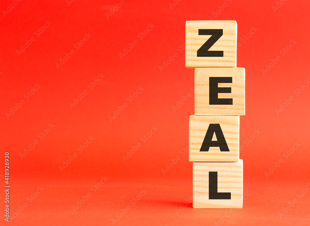 Wooden cubes with word ZEAL. Wooden cubes on a red background. Free space on the left. Wooden cubes with word ZEAL. Wooden cubes on a red background. Free space on the left.