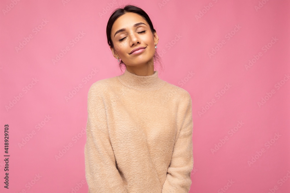 Photo of young beautiful happy cute brunette woman wearing beige jersey . Sexy carefree female person posing isolated near pink wall in studio with free space. Positive model with natural makeup Photo of young beautiful happy cute brunette woman wearing beige jersey . Sexy carefree female person posing isolated near pink wall in studio with free space. Positive model with natural makeup