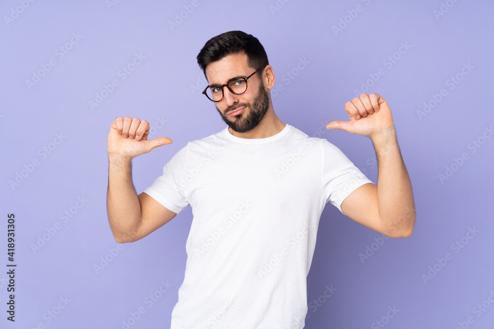 Fototapeta premium Caucasian handsome man over isolated background proud and self-satisfied