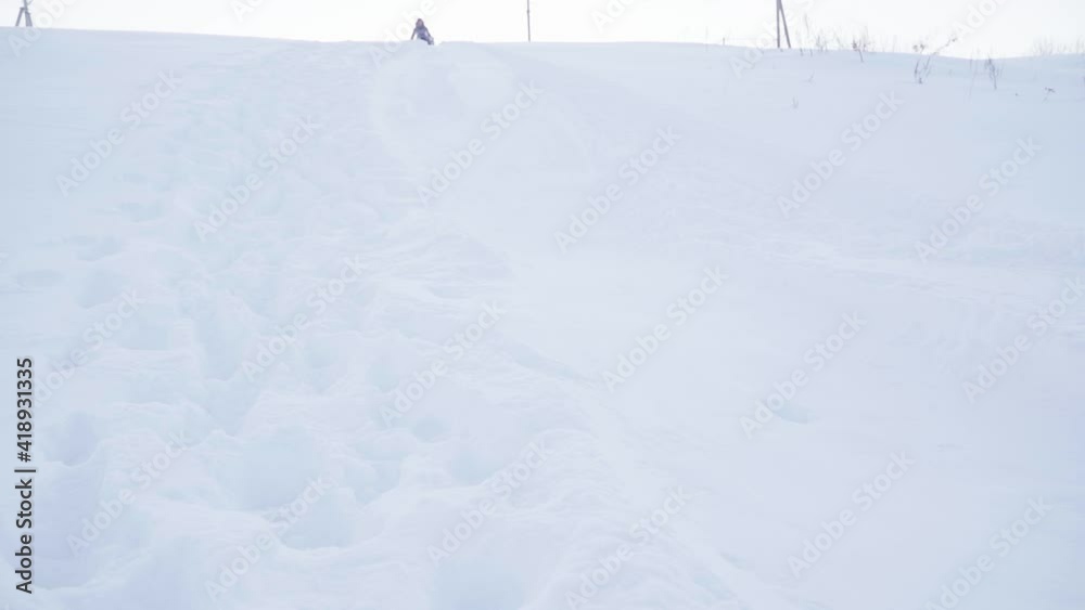 A woman on a snow tube in winter time A woman on a snow tube in winter time