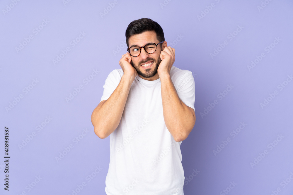 Caucasian handsome man over isolated background frustrated and covering ears Caucasian handsome man over isolated background frustrated and covering ears
