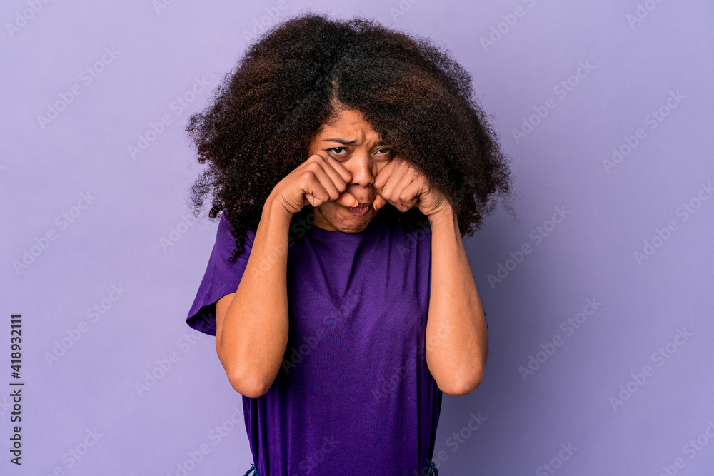 Young african american curly woman isolated on purple background whining and crying disconsolately. Young african american curly woman isolated on purple background whining and crying disconsolately.