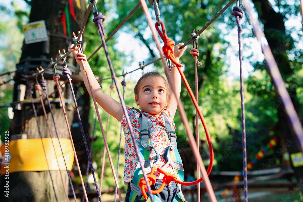 Rope Park. The kid passes the obstacle in the rope Park. Rope Park. The kid passes the obstacle in the rope Park.