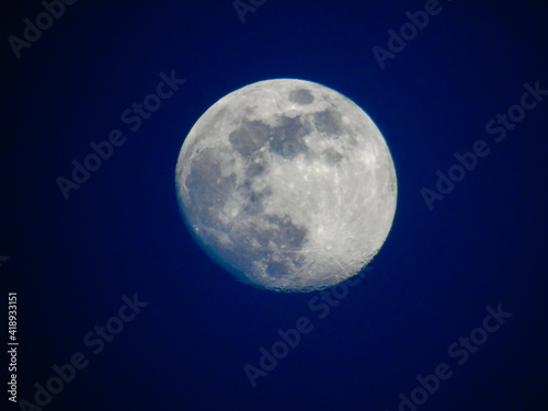 Earth s Moon Glowing with different colours in the Background. Blue and red moon watched by telescope.