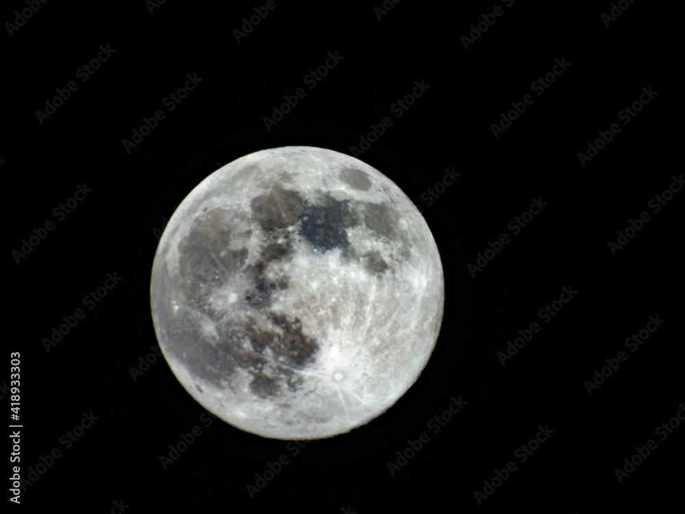 Obraz premium Earth's Moon Glowing with different colours in the Background. Blue and red moon watched by telescope.