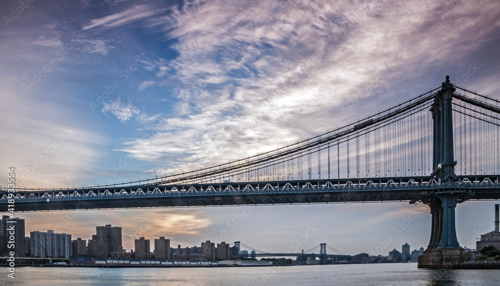 The Brooklyn bridge in  New York with the Manhattan skyline on the background.