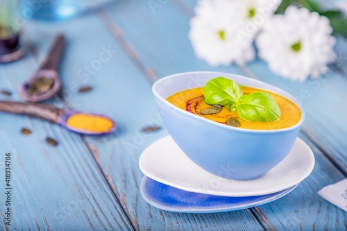 Pumpkin cream soup on a blue background