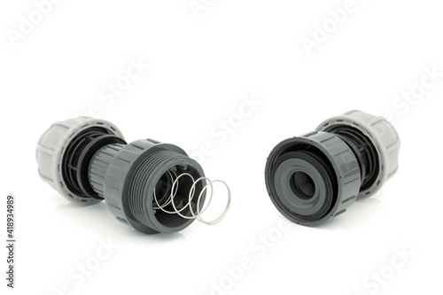 Konstfotografi Plastic MDPE non return value compression fitting showing inner workings used in plumbing to facilitate the flow of liquid in one direction only, on white background