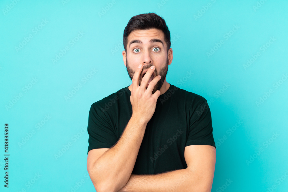 Caucasian handsome man isolated on blue background surprised and shocked while looking right Caucasian handsome man isolated on blue background surprised and shocked while looking right