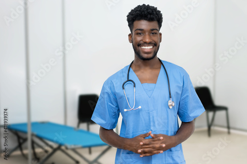 Laughing african male nurse at vaccination station