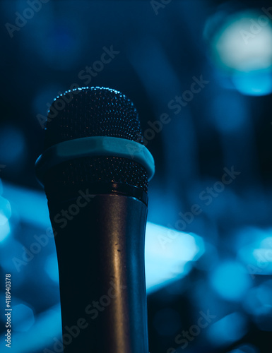 A stage microphone on a blue background