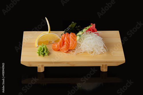 japanese foods sashimi raw sliced fish, shellfish or crustaceans on wooden board