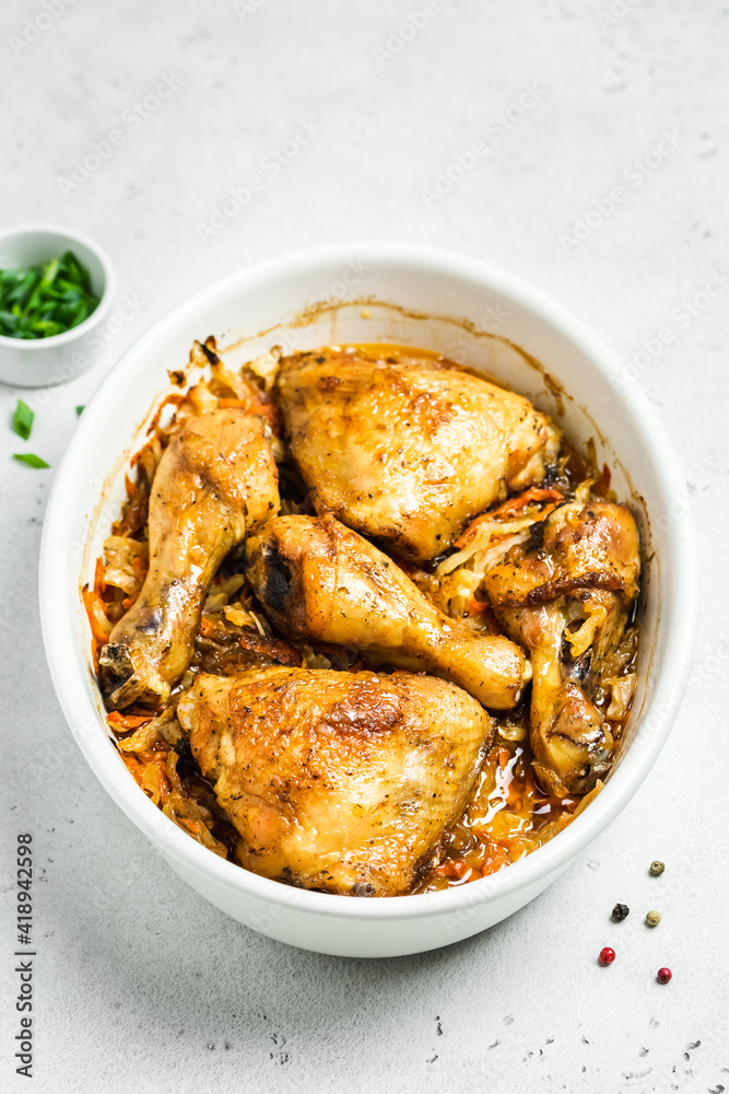 Oven roasted chicken with cabbage in baking dish. Space for text. Oven roasted chicken with cabbage in baking dish. Space for text.
