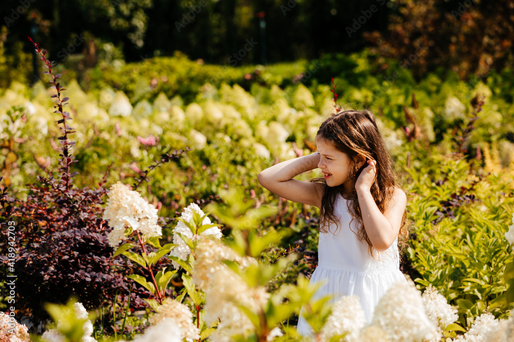 Little girls dancing among wonderful blooming flowers Little girls dancing among wonderful blooming flowers