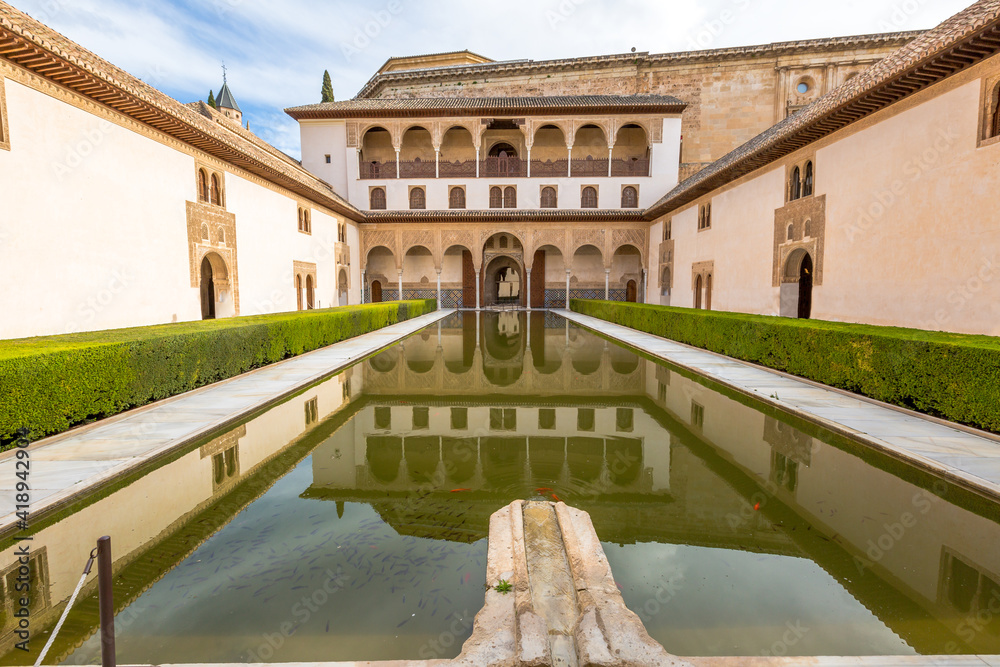 The Patio de los Arrayanes or courtyard of the Myrtles within the popular Palacios Nazaries, one of the most visited attractions of Alhambra de Granada Unesco Heritage in Andalusia, Spain.