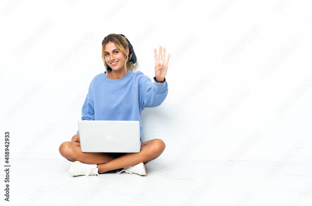 Young blonde Uruguayan girl with the laptop isolated on white background happy and counting four with fingers Young blonde Uruguayan girl with the laptop isolated on white background happy and counting four with fingers