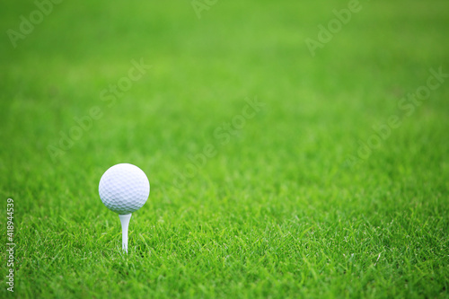 Golf ball on green grass background