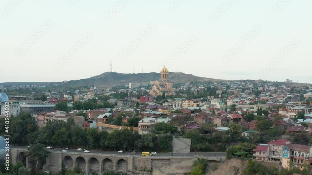 Beautiful aerial view of Tbilisi, Georgia, passing Presidential palace with Holy Trinity cathedral (Metekhi church) in the background. Pan to left. 4k footage. Beautiful aerial view of Tbilisi, Georgia, passing Presidential palace with Holy Trinity cathedral (Metekhi church) in the background. Pan to left. 4k footage.