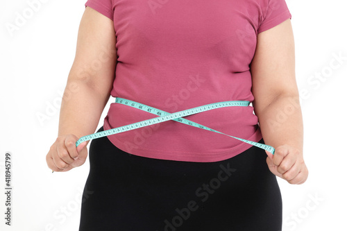 Fat Asian women use a Blue tape measure. Measure your belly size. Concept of weight loss, health problems of obese people. White background. isolated.