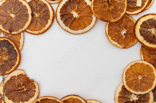 Dried orange slices on a white wooden background. Organic dried fruit. With writing area