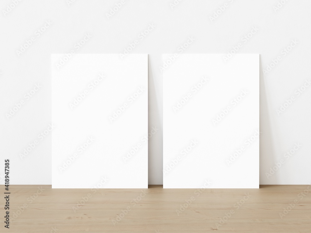 Set of two blank vertically oriented rectangular posters standing on wooden floor leaning on white wall. 3D Illustration Set of two blank vertically oriented rectangular posters standing on wooden floor leaning on white wall. 3D Illustration
