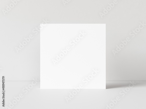 One blank square poster template standing on white table with white background. 3D illustration