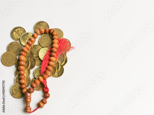 Canvas Print Image of coins with prayer beads isolated on white background