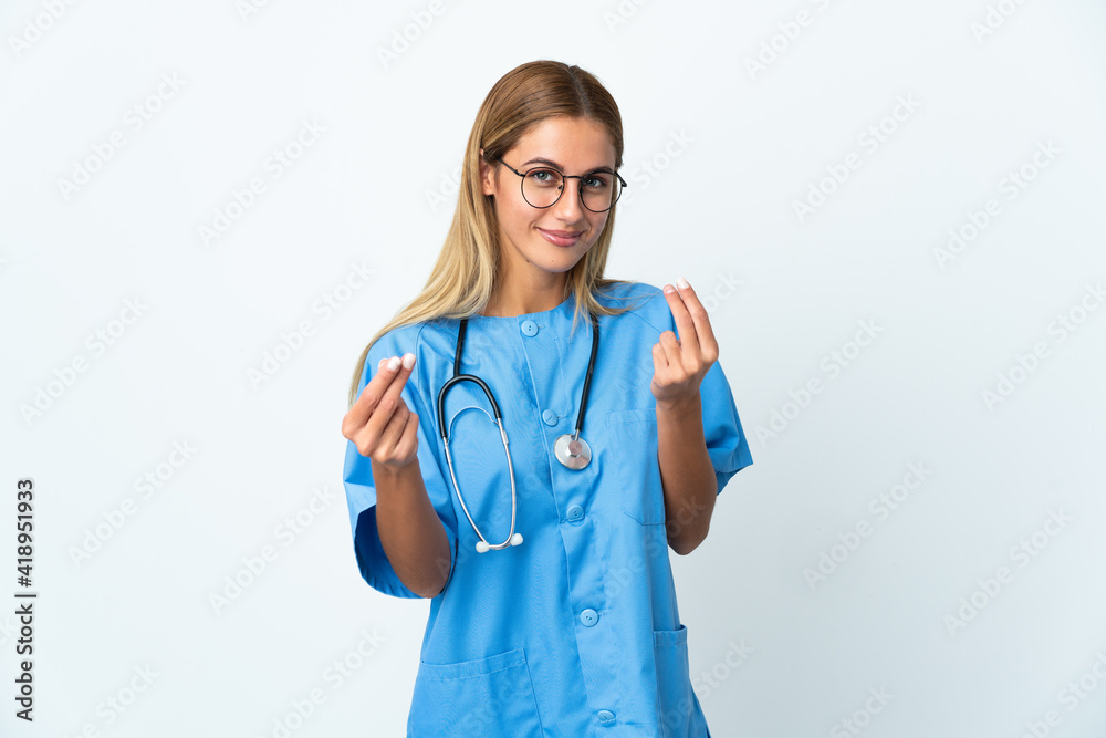 Surgeon doctor woman over isolated white background making money gesture Surgeon doctor woman over isolated white background making money gesture