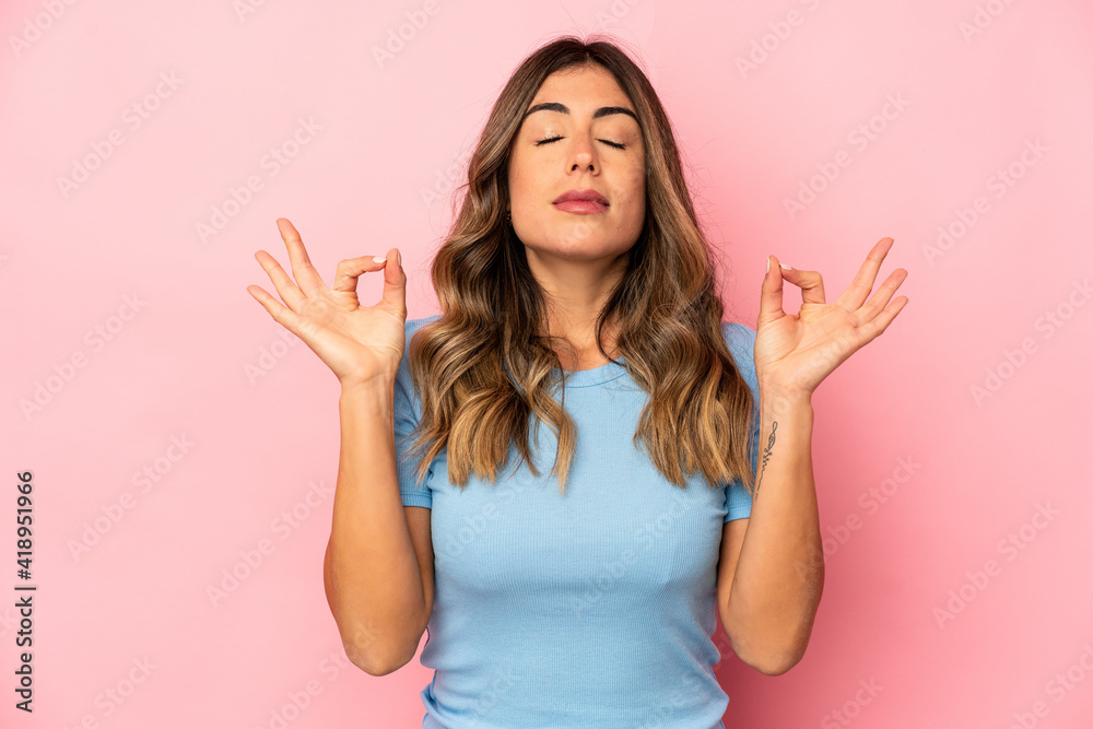 Young caucasian woman isolated relaxes after hard working day, she is performing yoga. Young caucasian woman isolated relaxes after hard working day, she is performing yoga.