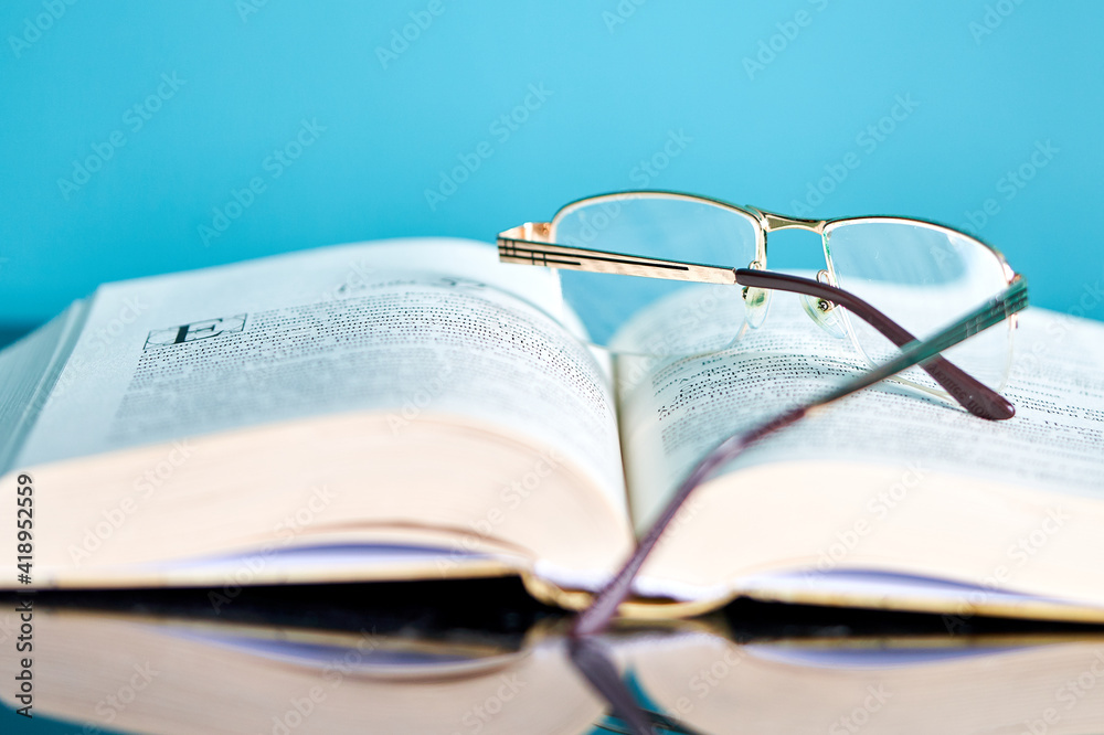 a stack of books and glasses are on the table a stack of books and glasses are on the table