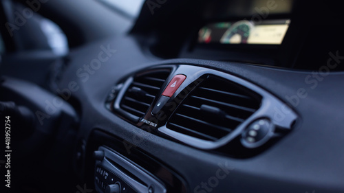 Ventilation vents with air flow deflectors and car emergency lights button. © kucheruk