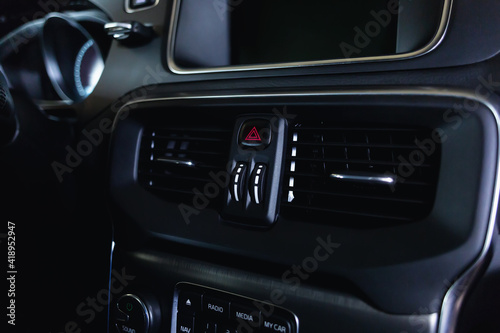 Ventilation vents with air flow deflectors and car emergency lights button.
