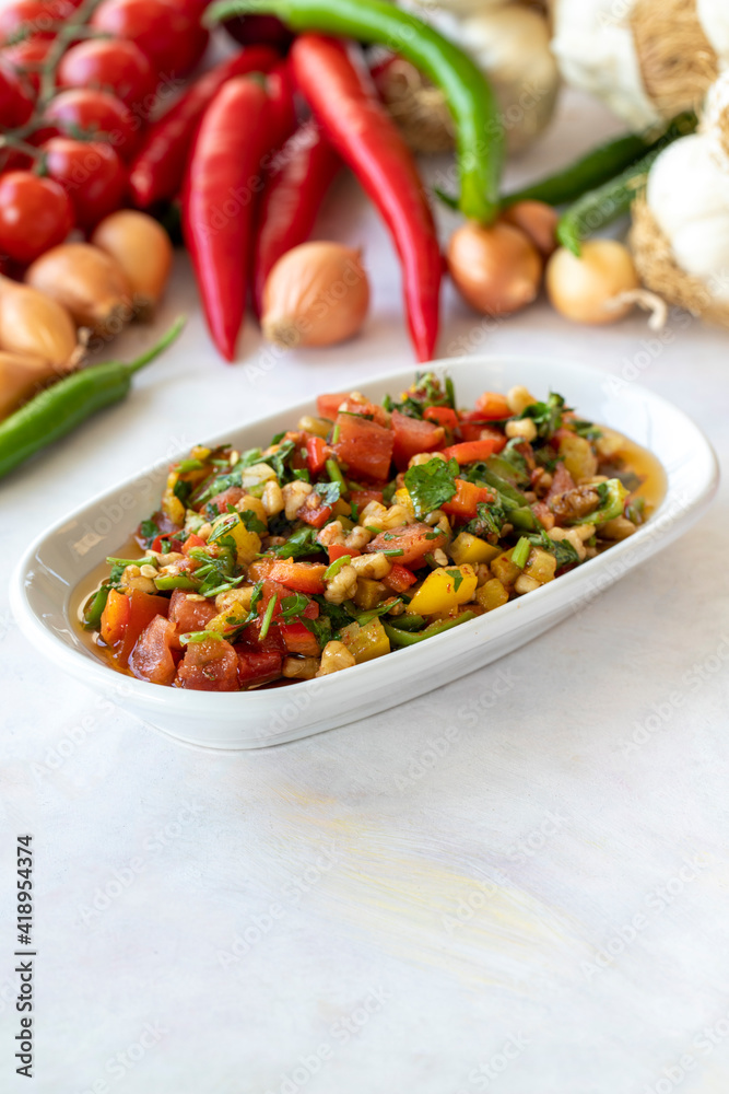 Healthy vegetarian food, traditional flavor Gavurdagi Salad with walnut. coban or choban salad. Mezze served alongside the main course. Appetizer Healthy vegetarian food, traditional flavor Gavurdagi Salad with walnut. coban or choban salad. Mezze served alongside the main course. Appetizer