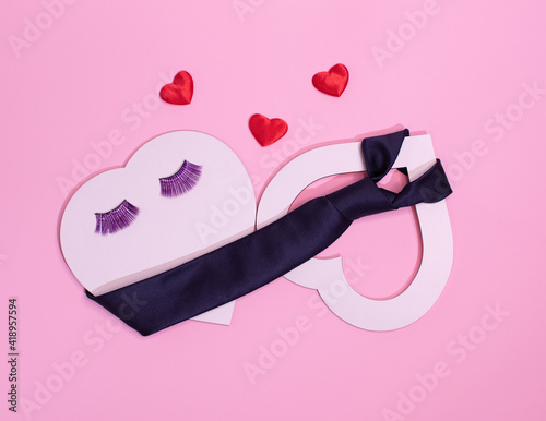 two hearts, love is ... the concept of lovers, she and he.Eyelashes and a tie