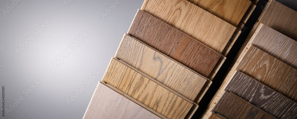 oak parquet flooring samples on gray background with copy space - obrazy, fototapety, plakaty 