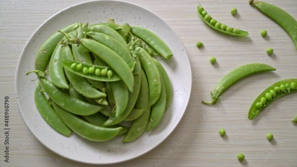 fresh sweet green peas on white plate fresh sweet green peas on white plate