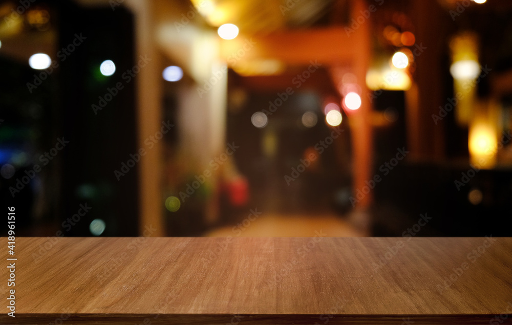 Empty dark wooden table in front of abstract blurred bokeh background of restaurant . can be used for display or montage your products.Mock up for space. Empty dark wooden table in front of abstract blurred bokeh background of restaurant . can be used for display or montage your products.Mock up for space.