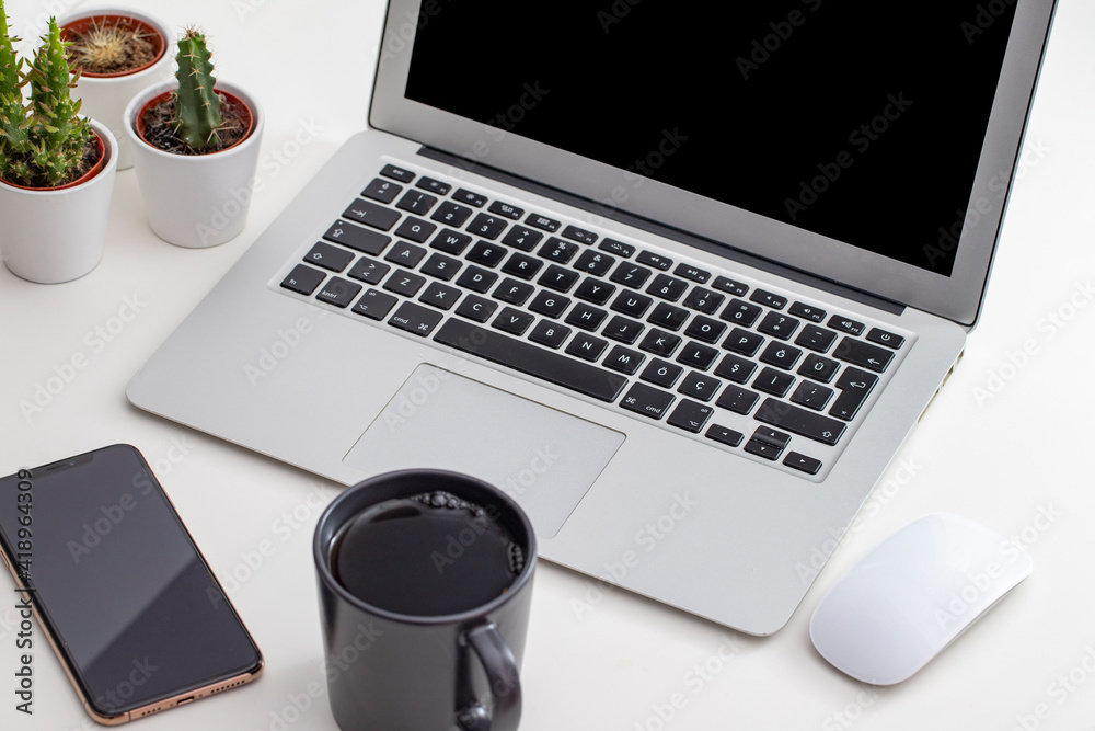 White desk office with laptop, smartphone and other work supplies with cup of coffee. Designer workspace on desk table essential elements on flat lay White desk office with laptop, smartphone and other work supplies with cup of coffee. Designer workspace on desk table essential elements on flat lay