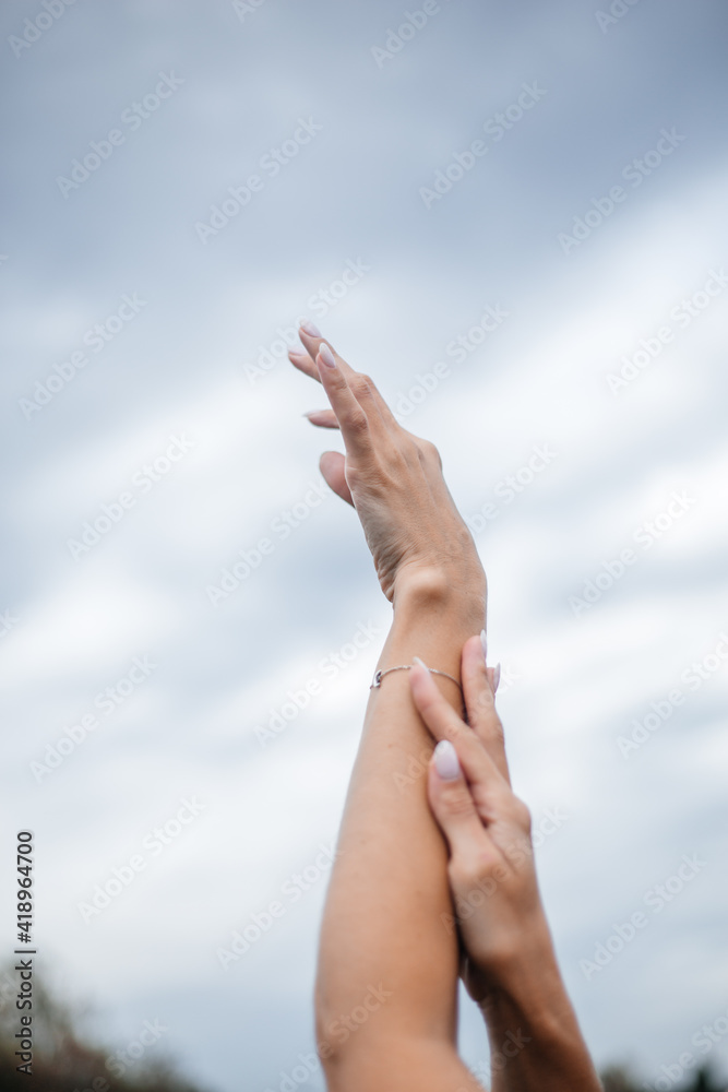 figure from female beautiful hands against the sky figure from female beautiful hands against the sky
