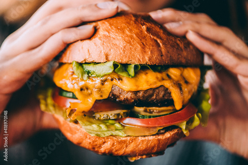 person eating  cheeseburger photo