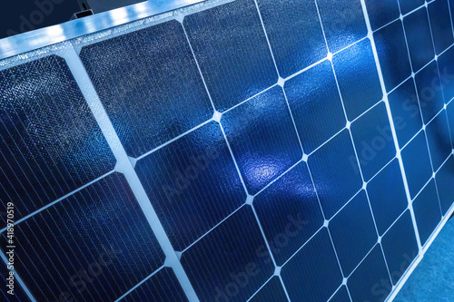 Solar panels close up. Concept - sale of solar equipment. Background on theme of saving energy. Solar panel is located indoors. Background symbolizes green energy. Electricity from renewable sources