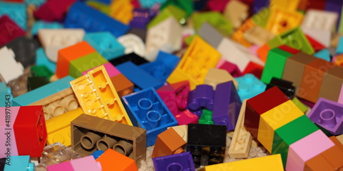 A lot colorful bricks from the children's model kit, a texture for the background