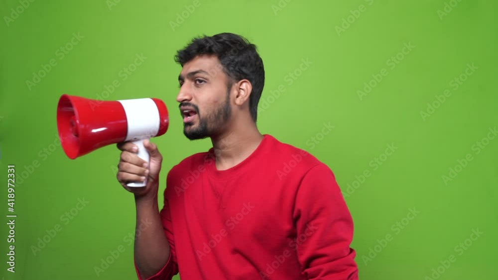 Man indian shouting through a megaphone on green screen chroma key Man indian shouting through a megaphone on green screen chroma key