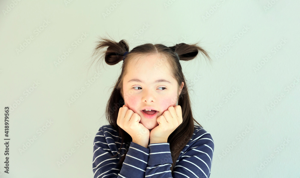 Cute smiling down syndrome girl on the white background Cute smiling down syndrome girl on the white background