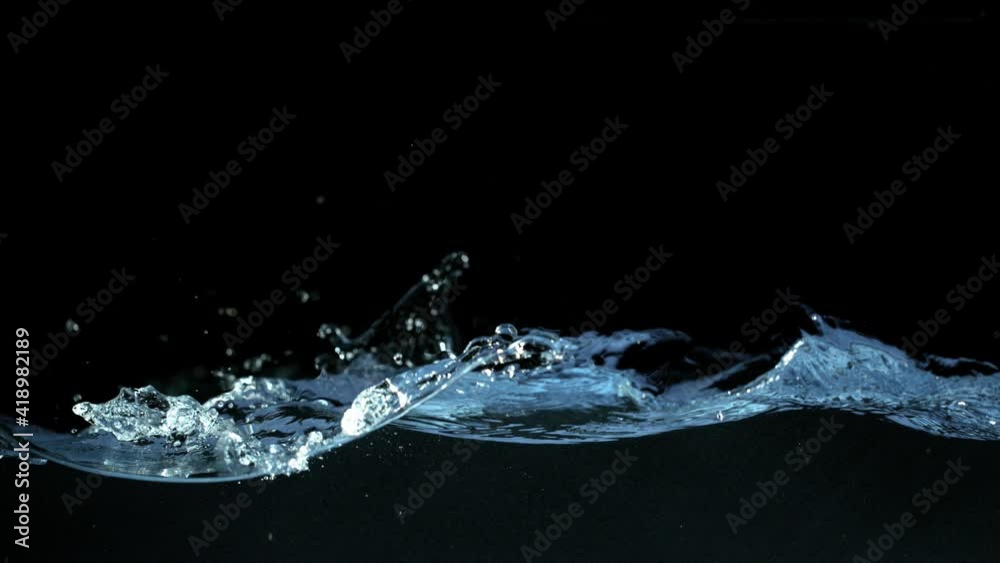 Super slow motion of waving water isolated on black background. Filmed on high speed cinema camera, 1000 fps.