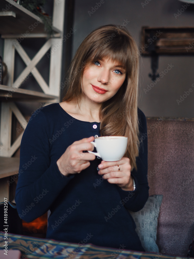 Image of young blonde pretty woman with blue eyes cup of coffee enjoying life in trendy city cafe vertical portrait for social platform stories Image of young blonde pretty woman with blue eyes cup of coffee enjoying life in trendy city cafe vertical portrait for social platform stories