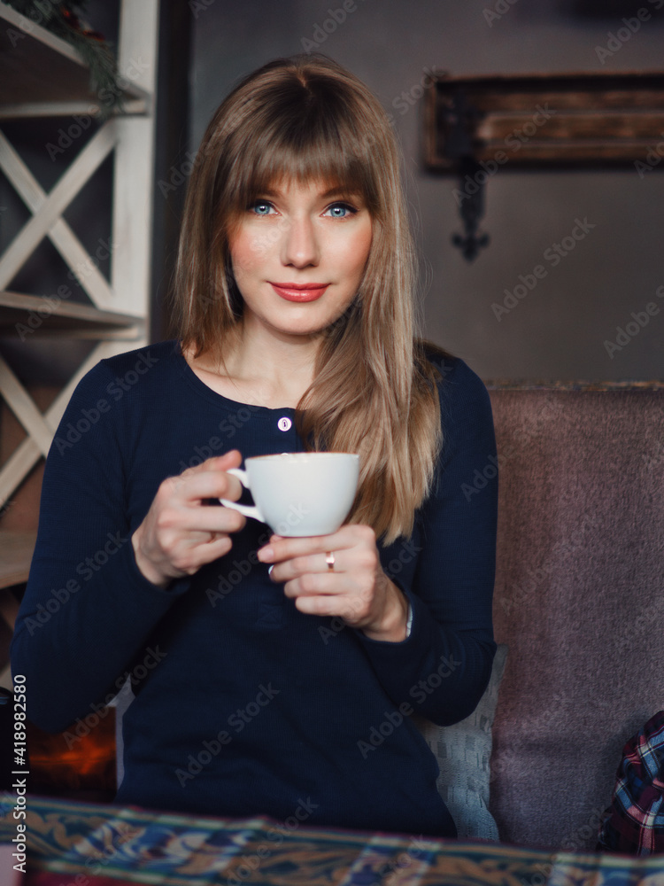 Image of young blonde pretty woman with blue eyes cup of coffee enjoying life in trendy city cafe vertical portrait for social platform stories
