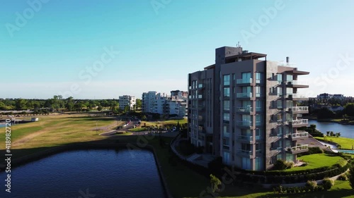 Side-Traveling Aerial Shot Over Luxury Apartment Buildings and Bay, In Nordelta, Buenos Aires, Argentina. photo