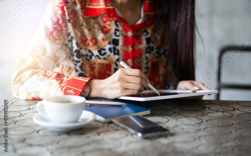 Close up young female using mobile app in digital tablet working online