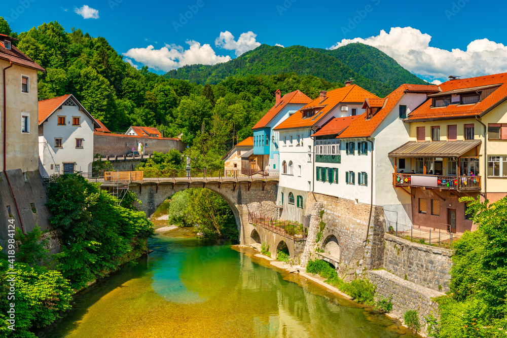 Cityscape of Škofja Loka, Slovenia. View of the Capuchin Bridge over the Selška Sora River in the old city center